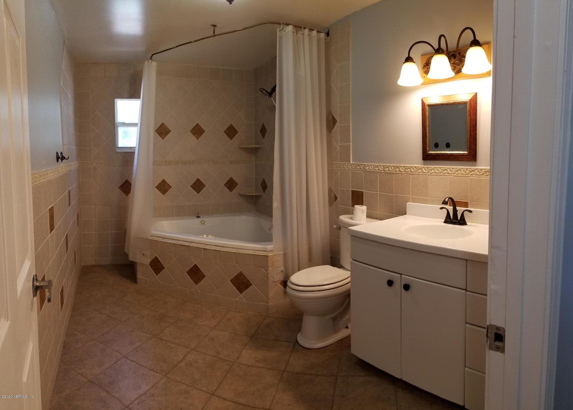 2544 Sam Road Jacksonville, FL 32216 - Photo 14 of 39 a bathroom with a sink a toilet and shower