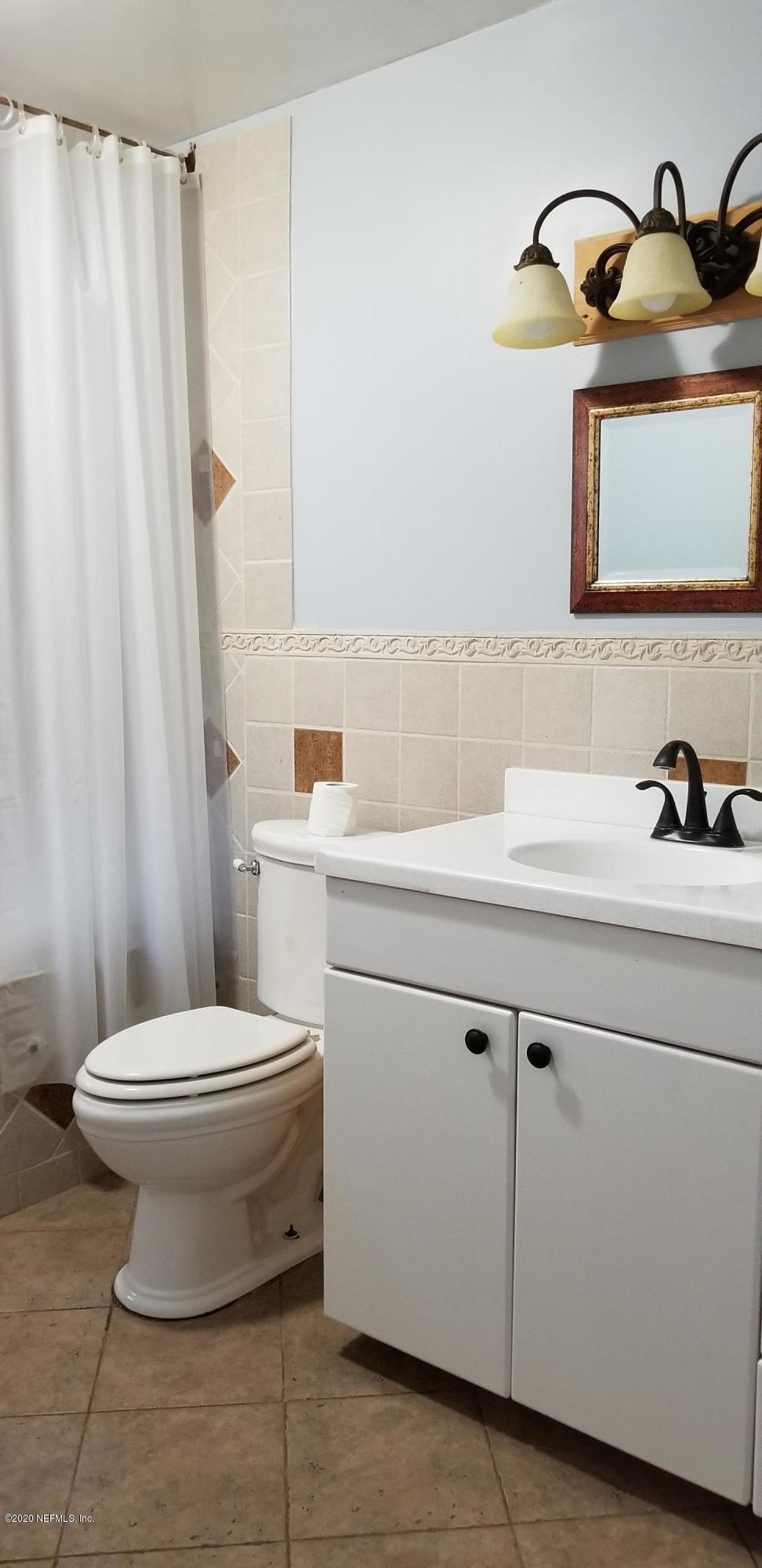 2544 Sam Road Jacksonville, FL 32216 - Photo 16 of 39 a bathroom with a sink toilet and a mirror