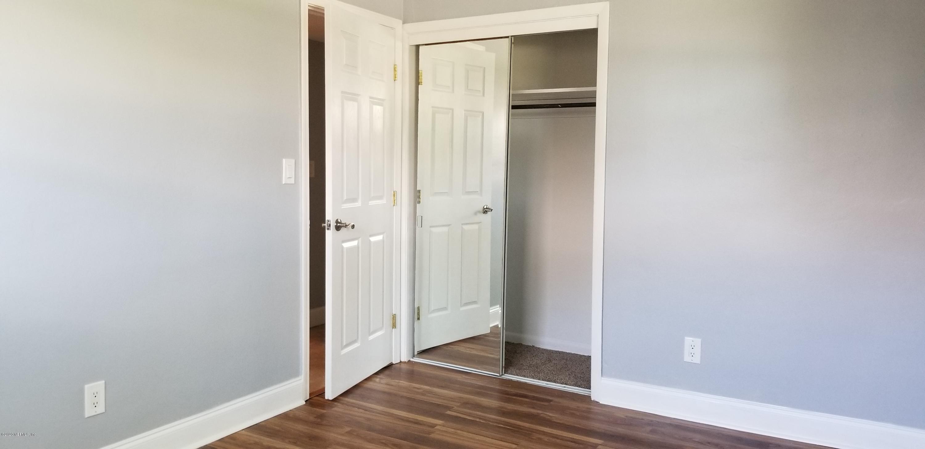 2544 Sam Road Jacksonville, FL 32216 - Photo 19 of 39 a view of an empty room with wooden floor