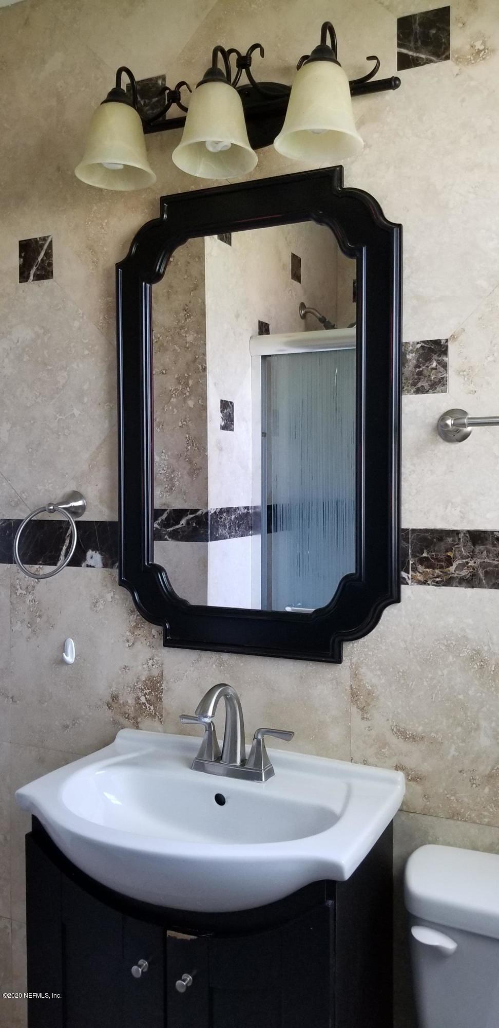 2544 Sam Road Jacksonville, FL 32216 - Photo 23 of 39 a bathroom with a sink and a mirror