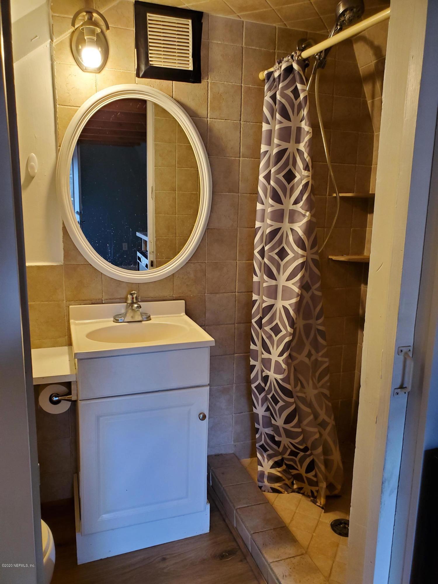 2544 Sam Road Jacksonville, FL 32216 - Photo 32 of 39 a bathroom with a sink and mirror