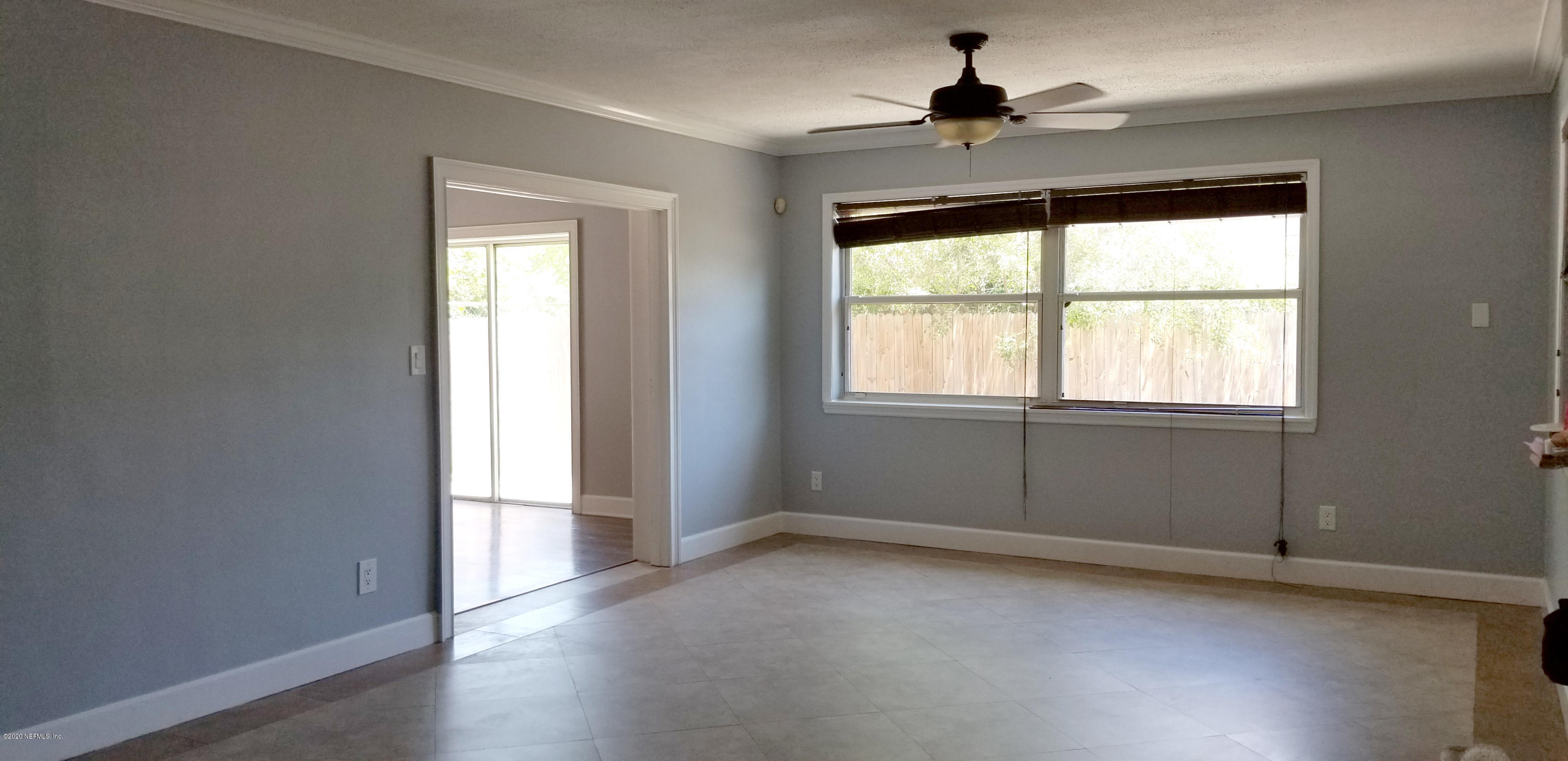 2544 Sam Road Jacksonville, FL 32216 - Photo 4 of 39 wooden floor in an empty room with a window