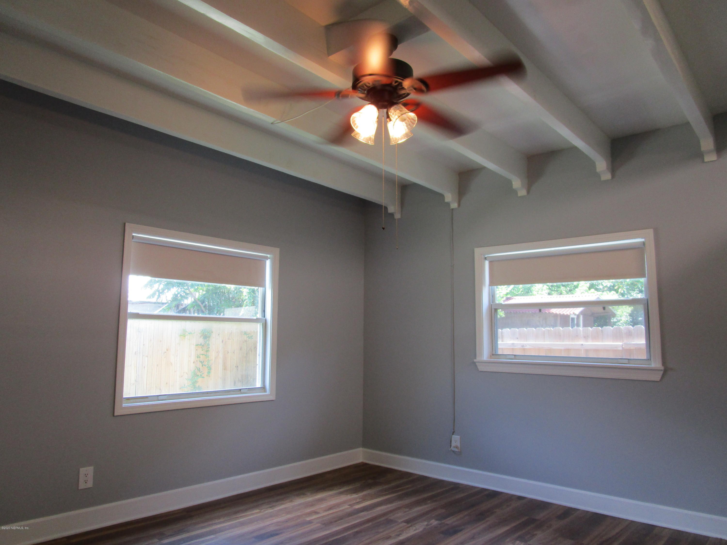 2544 Sam Road Jacksonville, FL 32216 - Photo 9 of 39 a view of an empty room with wooden floor and a window