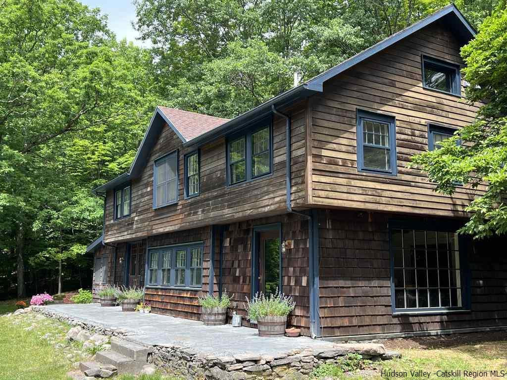 324 Upper Byrdcliffe Road Woodstock, NY 12498 - Photo 1 of 34 a front view of a house with a yard