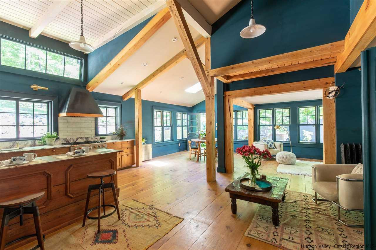 324 Upper Byrdcliffe Road Woodstock, NY 12498 - Photo 12 of 34 a living room with fireplace furniture and a large window