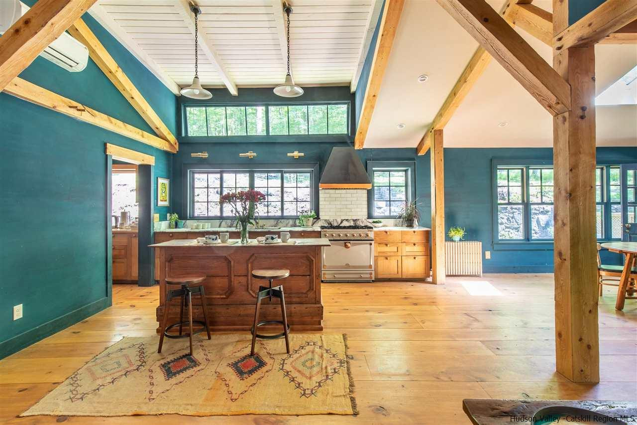 324 Upper Byrdcliffe Road Woodstock, NY 12498 - Photo 16 of 34 a dining room with furniture and a floor to ceiling window