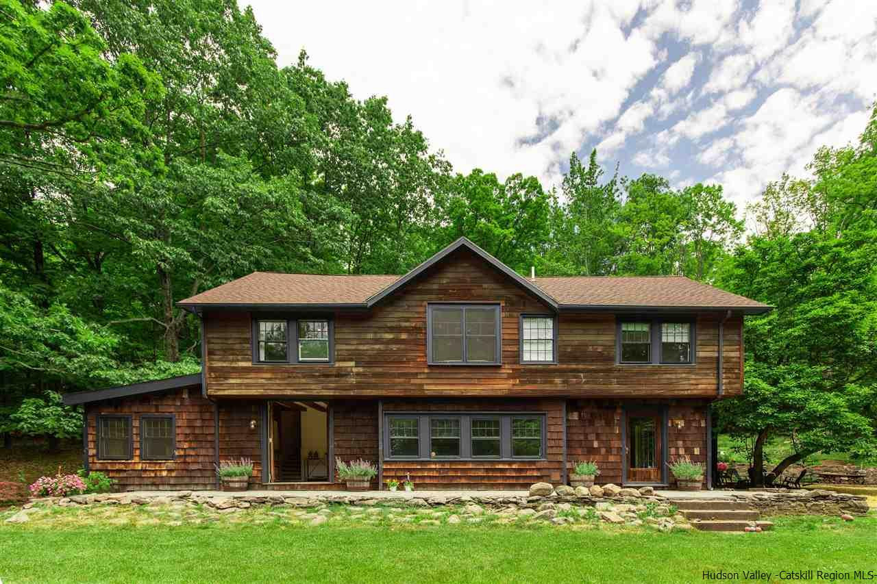 324 Upper Byrdcliffe Road Woodstock, NY 12498 - Photo 2 of 34 a front view of a house with garden