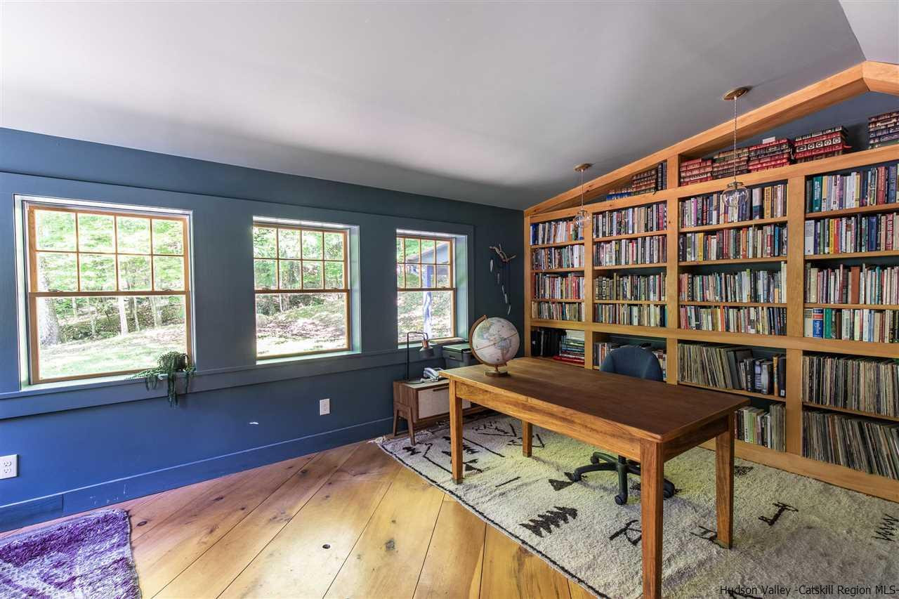 324 Upper Byrdcliffe Road Woodstock, NY 12498 - Photo 23 of 34 a view of a workspace with furniture and a book shelf