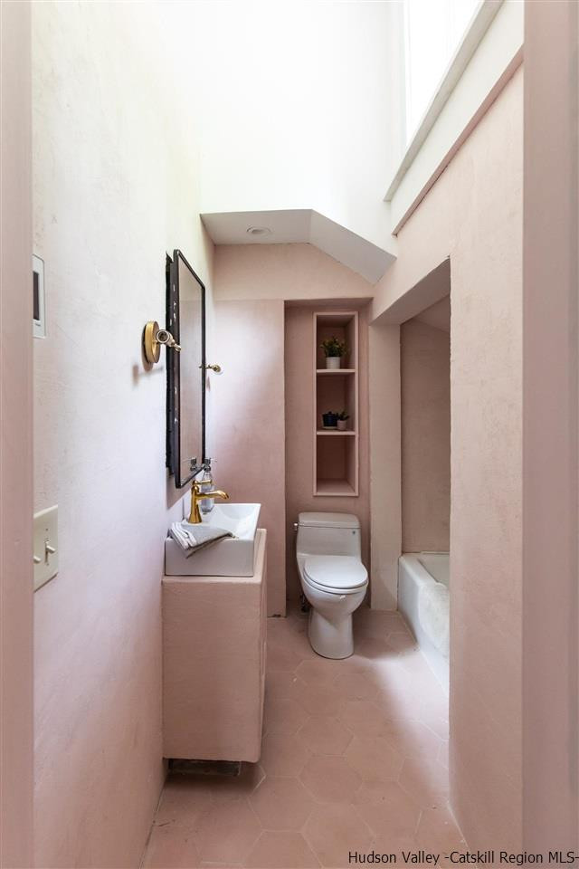 324 Upper Byrdcliffe Road Woodstock, NY 12498 - Photo 26 of 34 a bathroom with a toilet sink and mirror