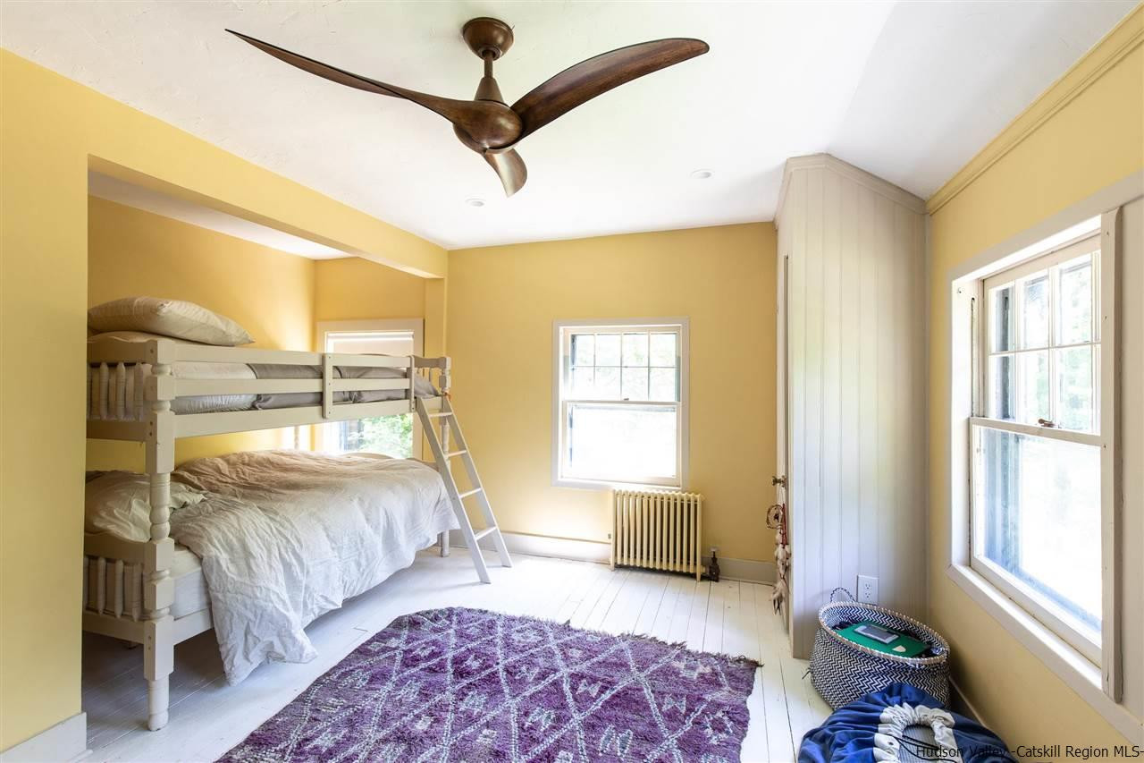 324 Upper Byrdcliffe Road Woodstock, NY 12498 - Photo 32 of 34 a bedroom with a bed and glass window