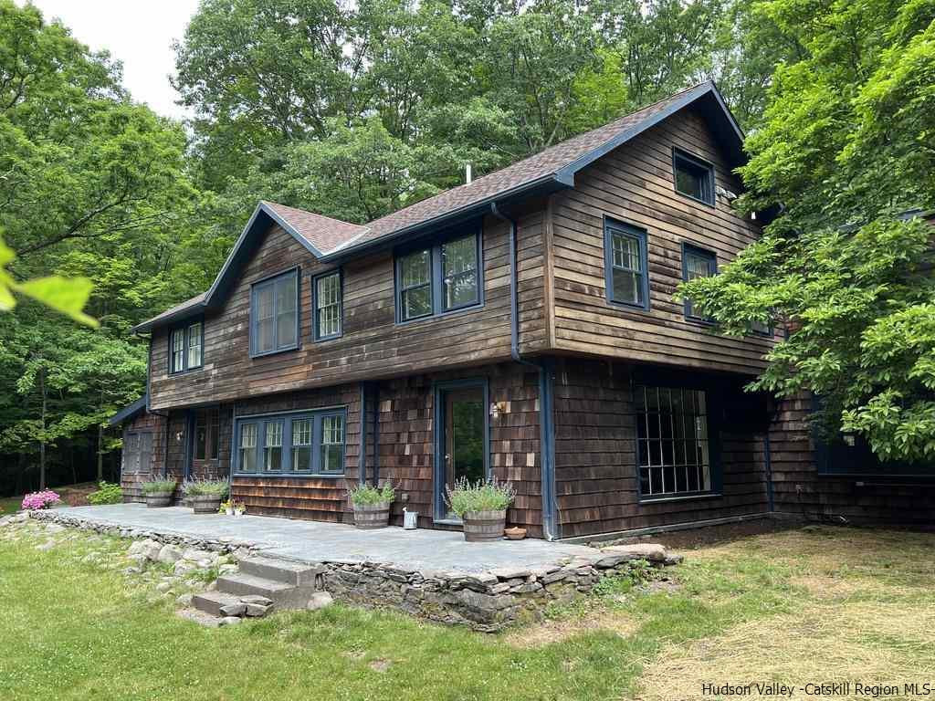 324 Upper Byrdcliffe Road Woodstock, NY 12498 - Photo 4 of 34 a front view of a house with yard and porch