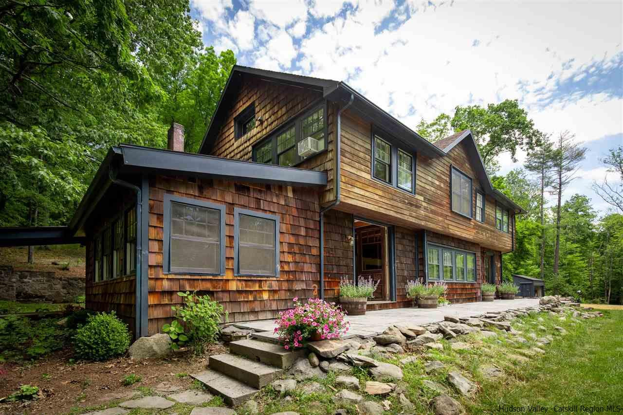 324 Upper Byrdcliffe Road Woodstock, NY 12498 - Photo 5 of 34 a front view of a house with a yard