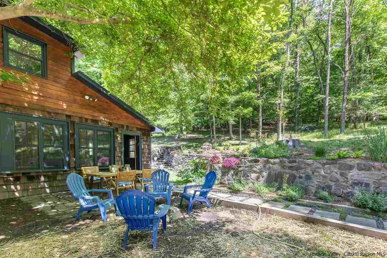 324 Upper Byrdcliffe Road Woodstock, NY 12498 - Photo 6 of 34 a view of a patio with table and chairs potted plants and large tree