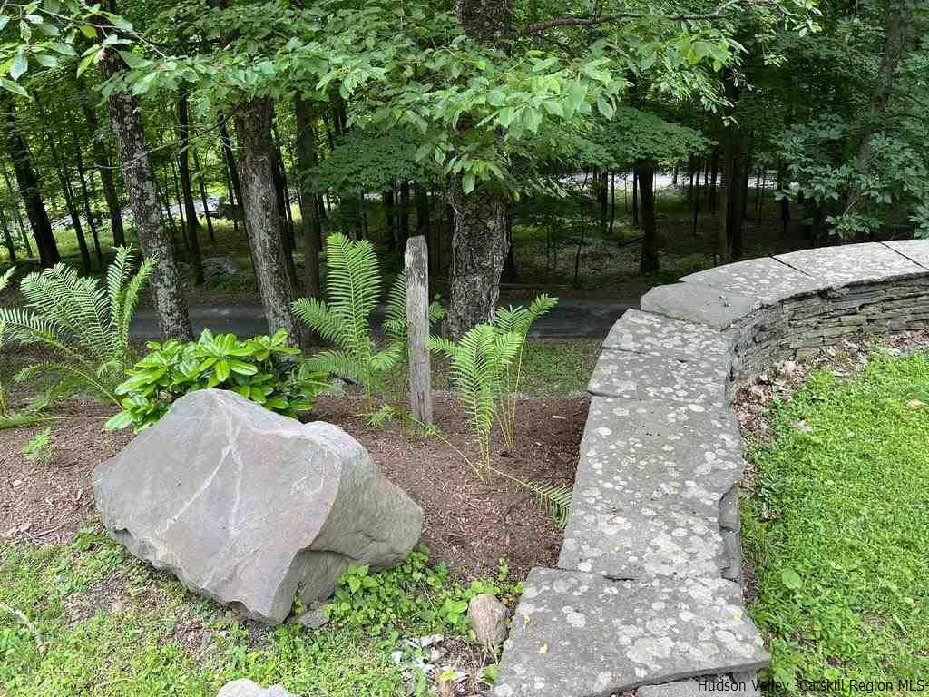 324 Upper Byrdcliffe Road Woodstock, NY 12498 - Photo 7 of 34 a view of a backyard with a fountain plants and large tree