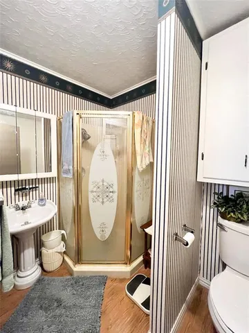 a view of a hallway with dining room and wooden floor