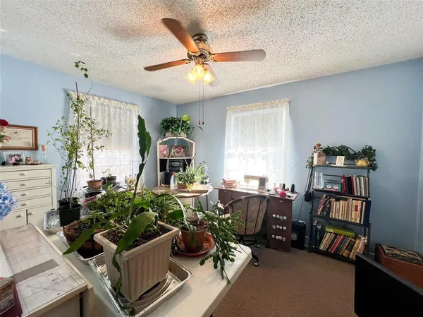 a living room with furniture and a bookshelf