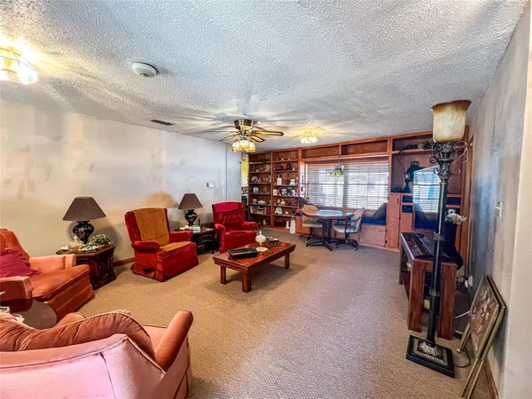 a living room with furniture a window and gym equipment