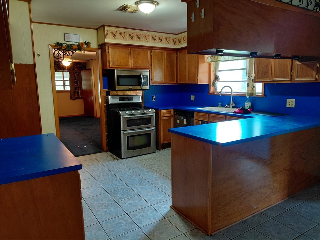 736 Northridge Street Angleton, TX 77515 - Photo 11 of 24 a kitchen with stainless steel appliances granite countertop a refrigerator and a stove