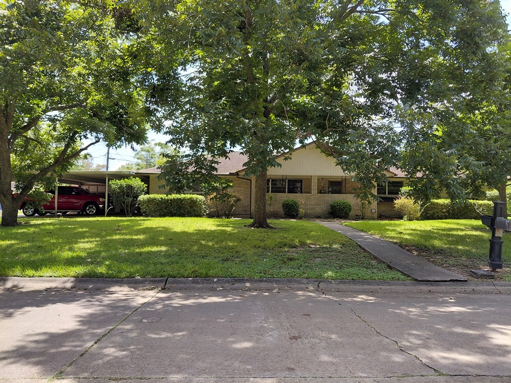 736 Northridge Street Angleton, TX 77515 - Photo 2 of 24 a front view of a house with a yard and trees