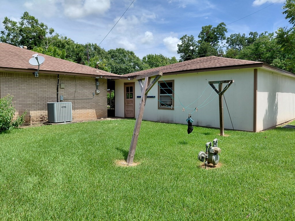 736 Northridge Street Angleton, TX 77515 - Photo 5 of 24 a backyard of a house with plants and barbeque oven