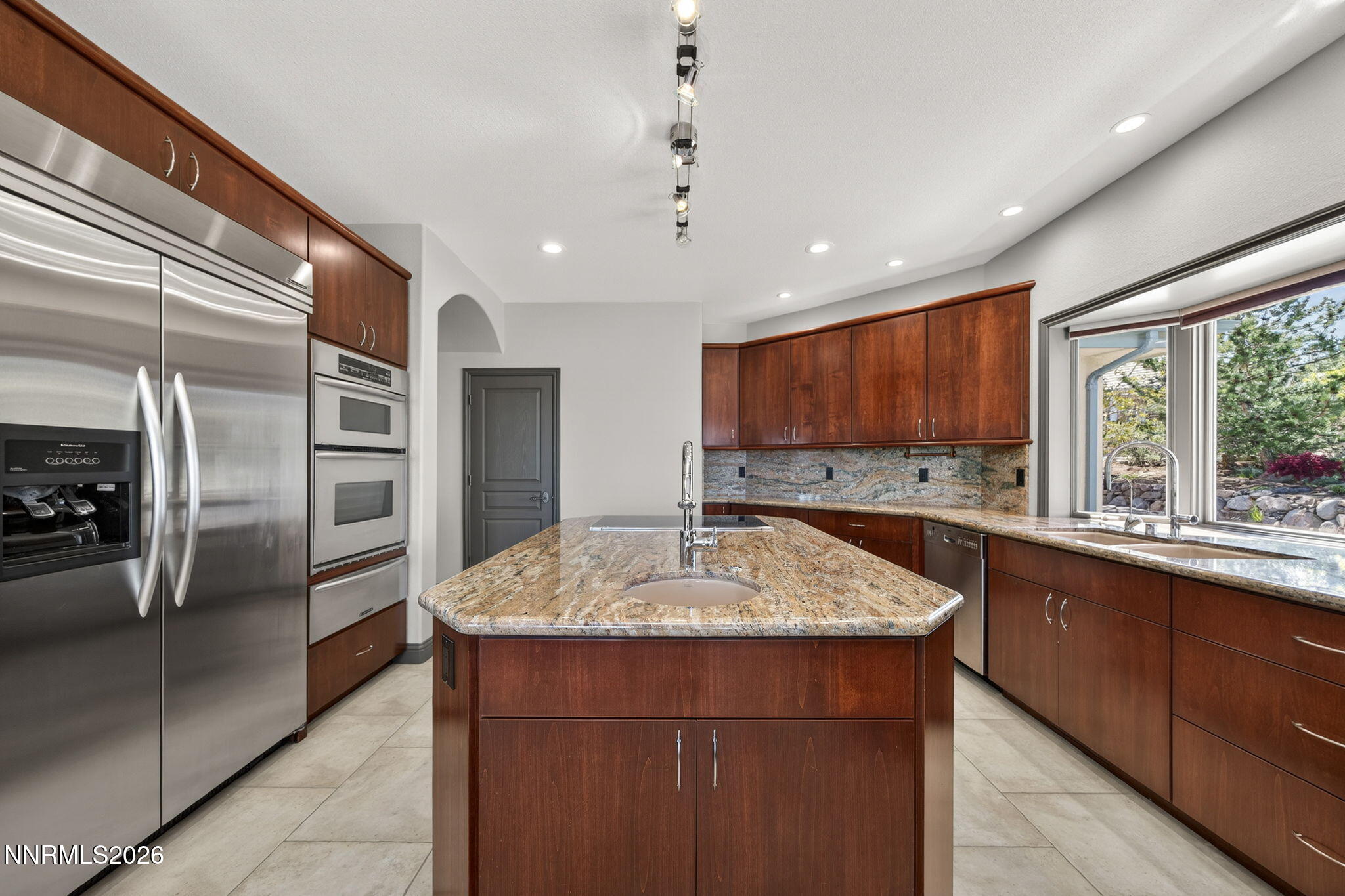3965 Lake Placid Drive Reno, NV 89511 - Photo 30 of 70 a kitchen with stainless steel appliances granite countertop a sink stove and refrigerator