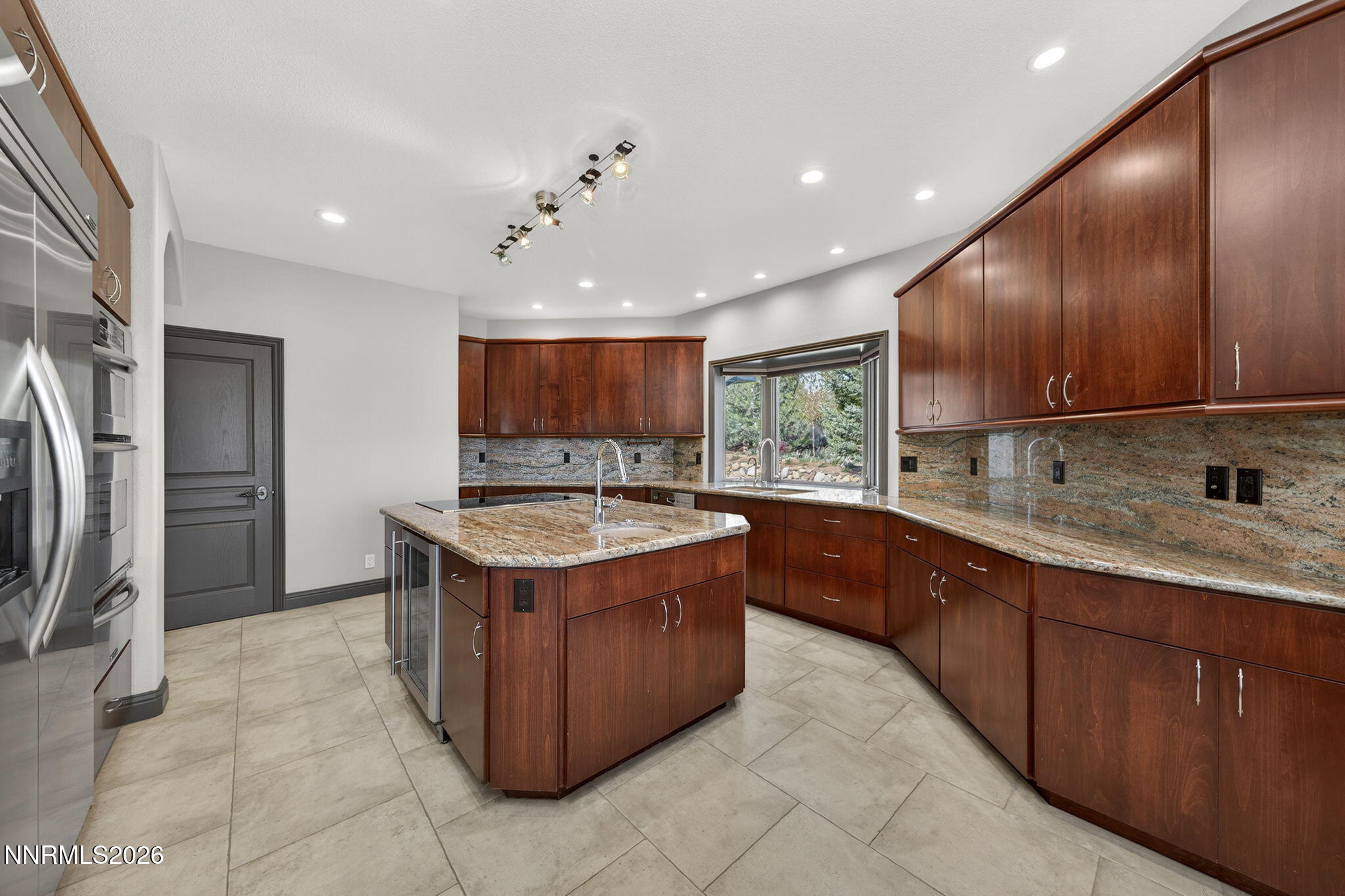 3965 Lake Placid Drive Reno, NV 89511 - Photo 33 of 70 a kitchen with stainless steel appliances granite countertop a stove a sink dishwasher and a refrigerator