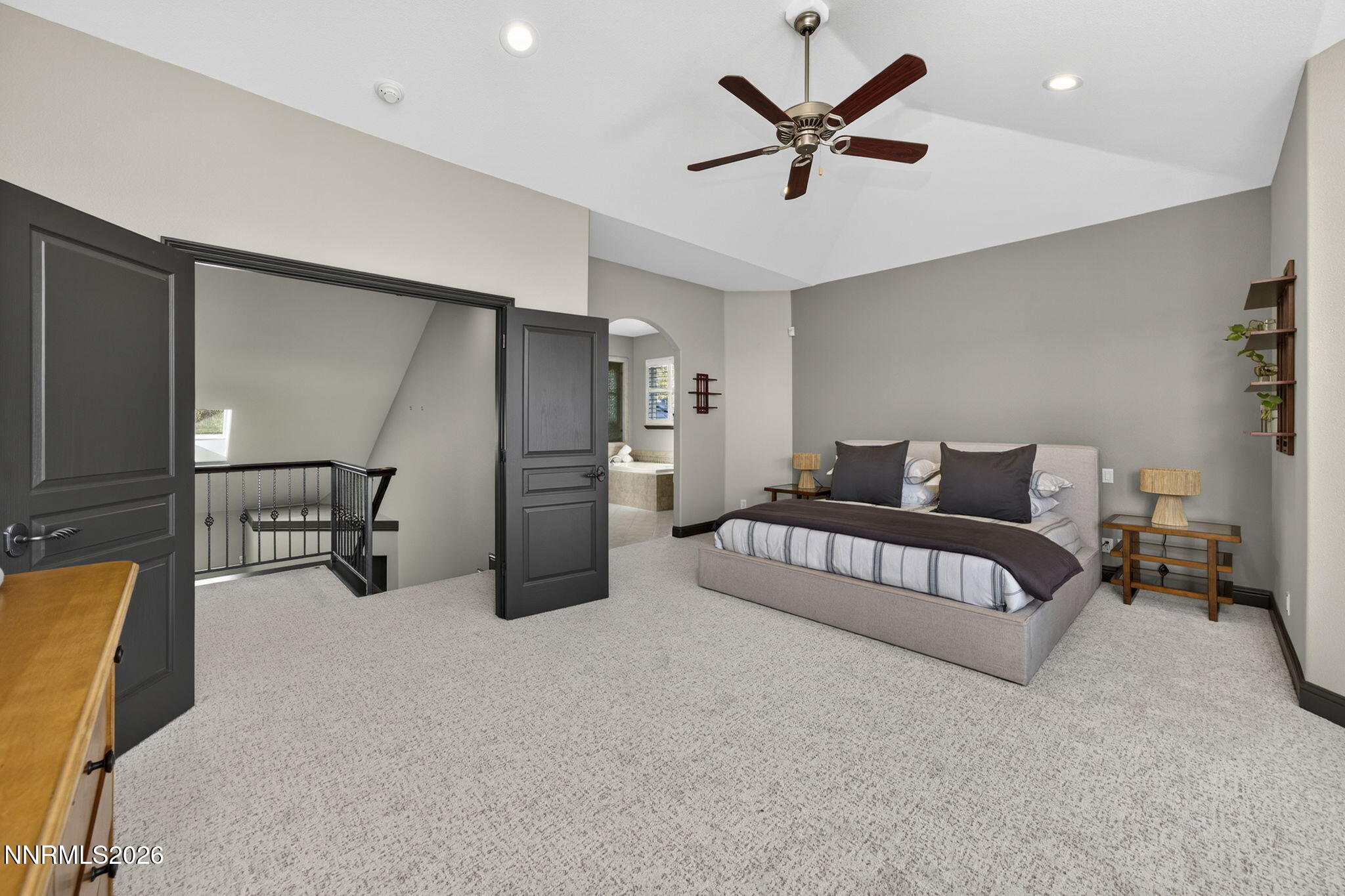 3965 Lake Placid Drive Reno, NV 89511 - Photo 55 of 70 a spacious bedroom with a bed a couch and a ceiling fan