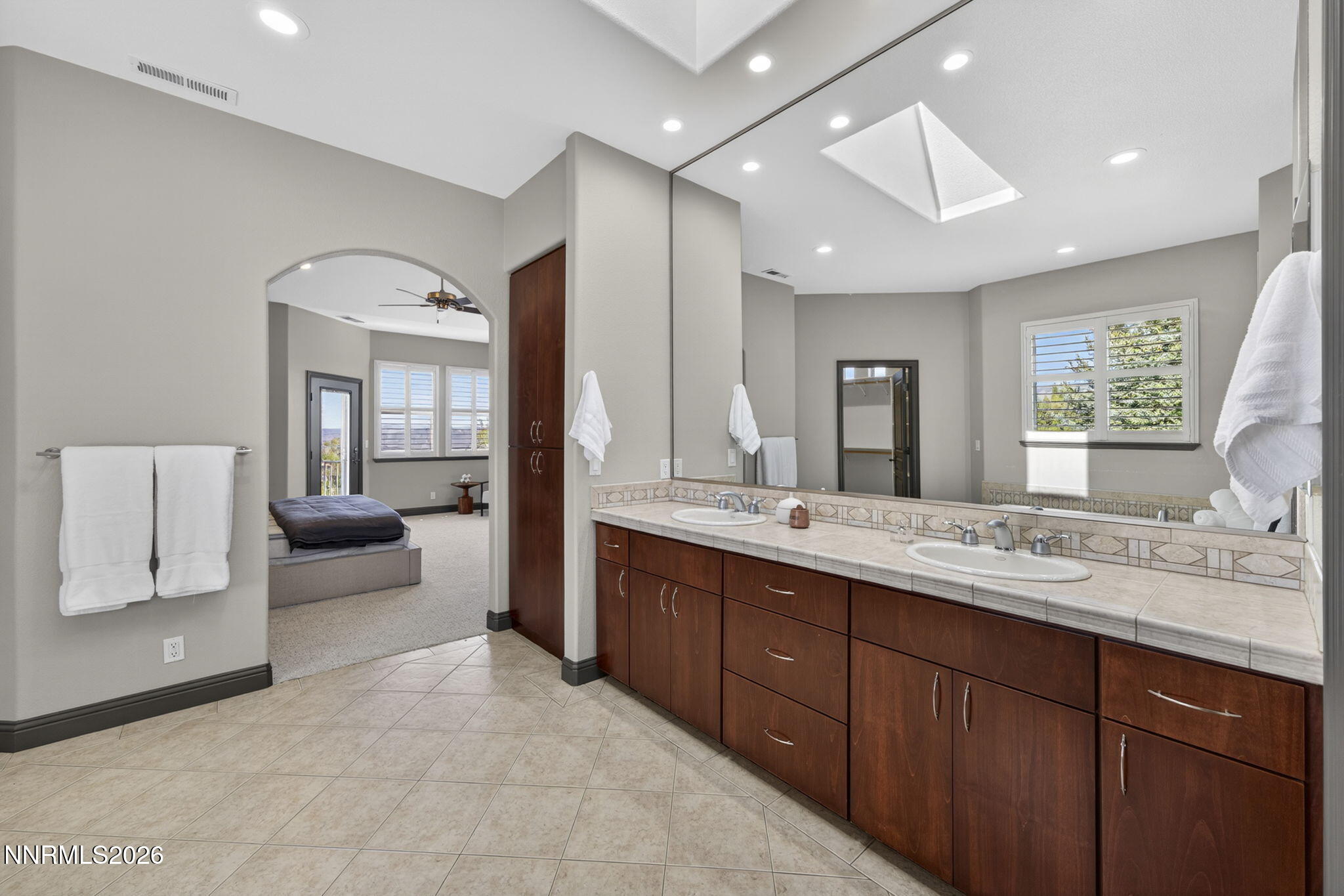 3965 Lake Placid Drive Reno, NV 89511 - Photo 59 of 70 a spacious bathroom with a double vanity sink large mirror and bathtub