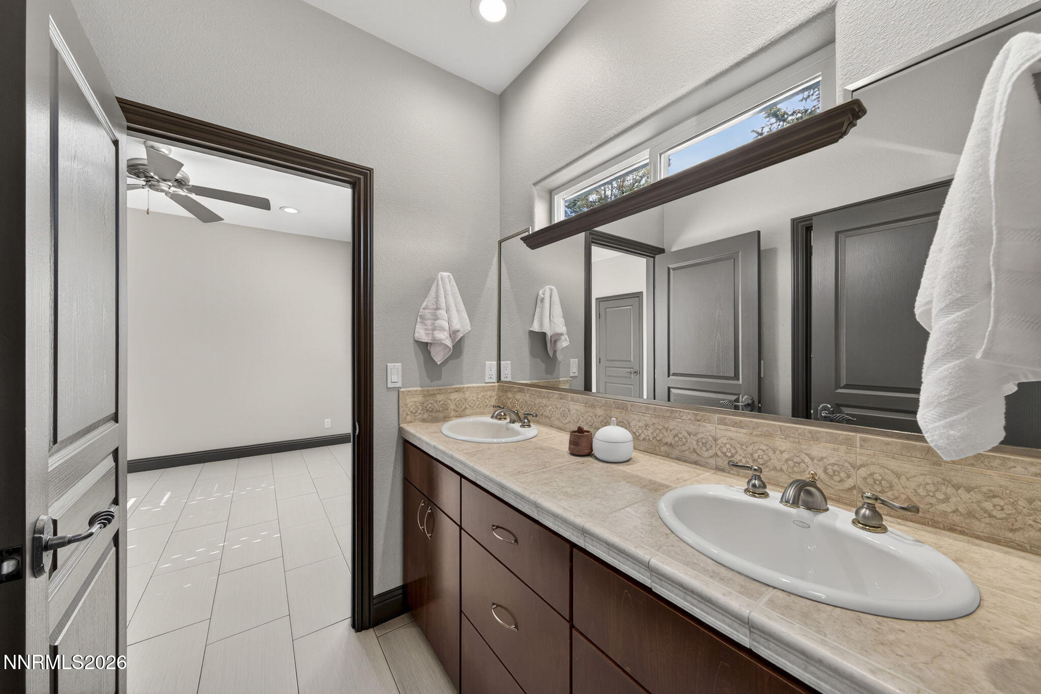 3965 Lake Placid Drive Reno, NV 89511 - Photo 63 of 70 a bathroom with a granite countertop sink and a mirror