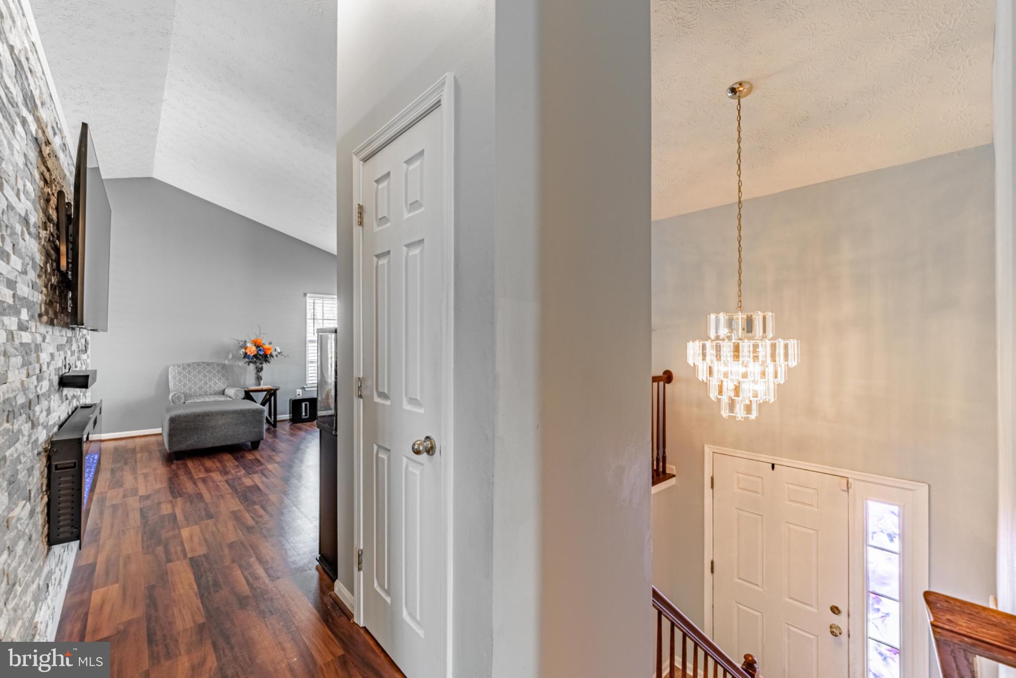 60 6 Point Court Baltimore, MD 21244 - Photo 6 of 28 a view of a livingroom with furniture wooden floor a flat screen tv and a chandelier