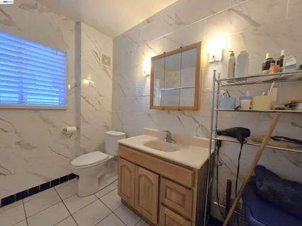 a bathroom with a sink toilet and mirror