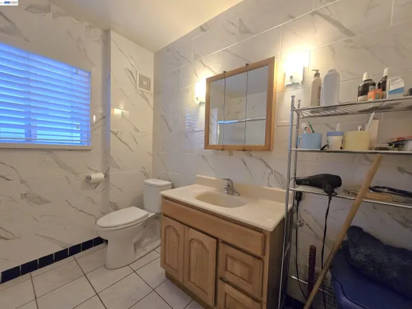 a bathroom with a sink toilet and mirror