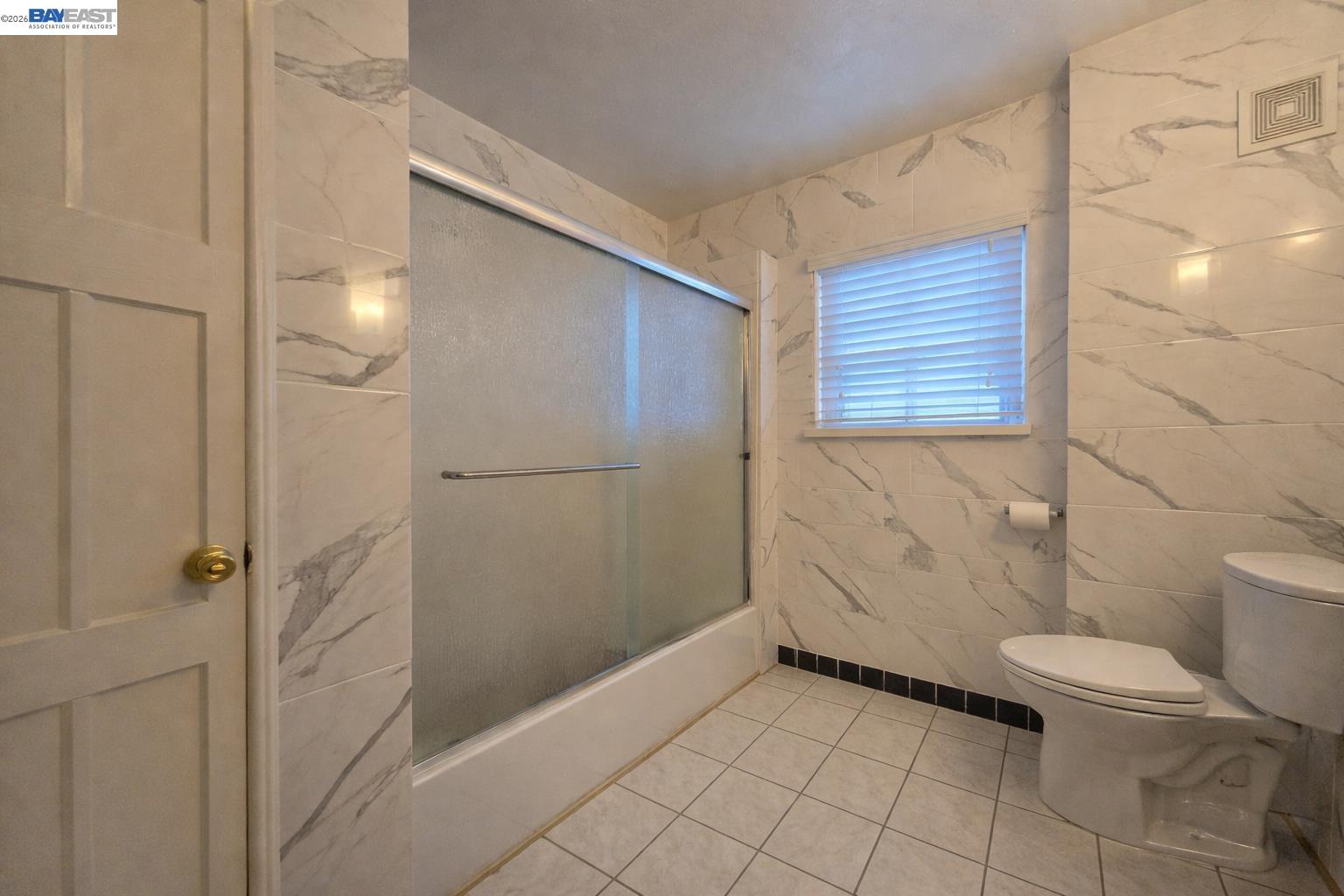 2917 Telegraph Avenue Berkeley, CA 94705 - Photo 4 of 12 a bathroom with a granite countertop shower and a toilet
