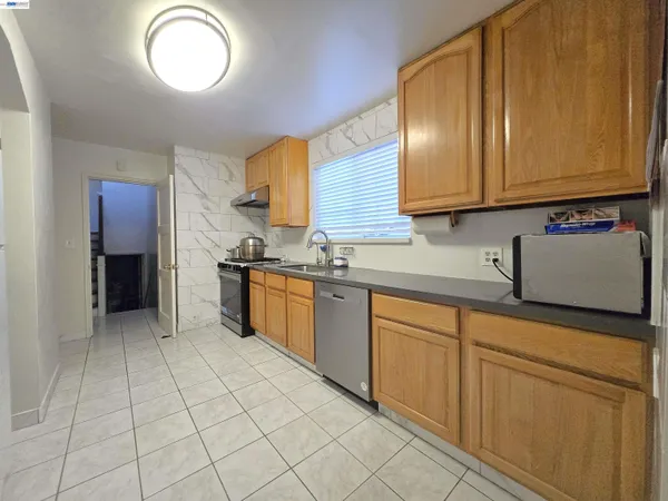 a kitchen with stainless steel appliances granite countertop a sink and cabinets