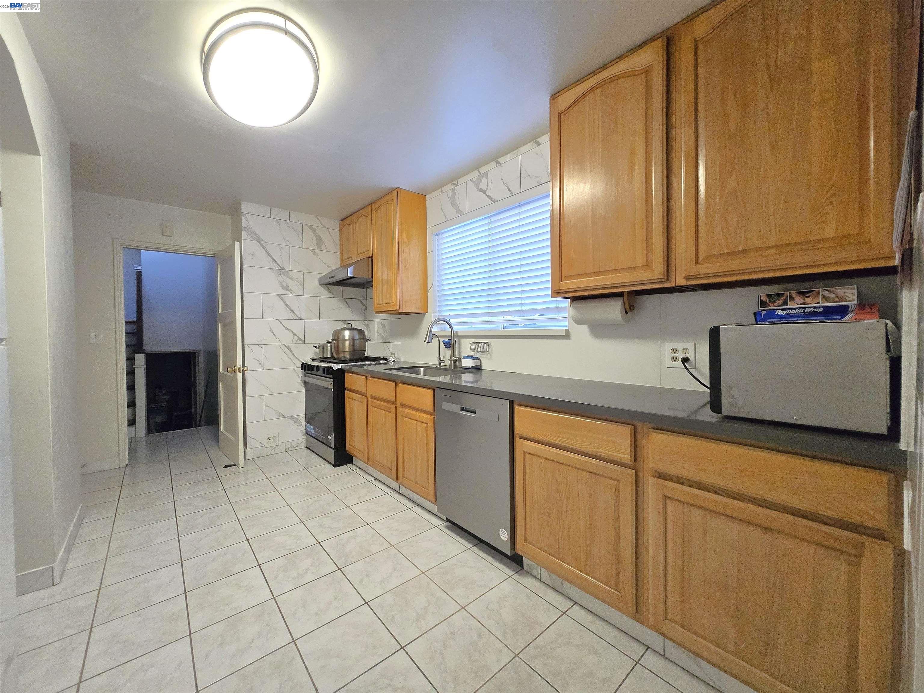 2917 Telegraph Avenue Berkeley, CA 94705 - Photo 7 of 12 a kitchen with stainless steel appliances granite countertop a sink and cabinets