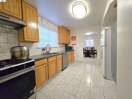 a kitchen with stainless steel appliances granite countertop a stove sink and cabinets