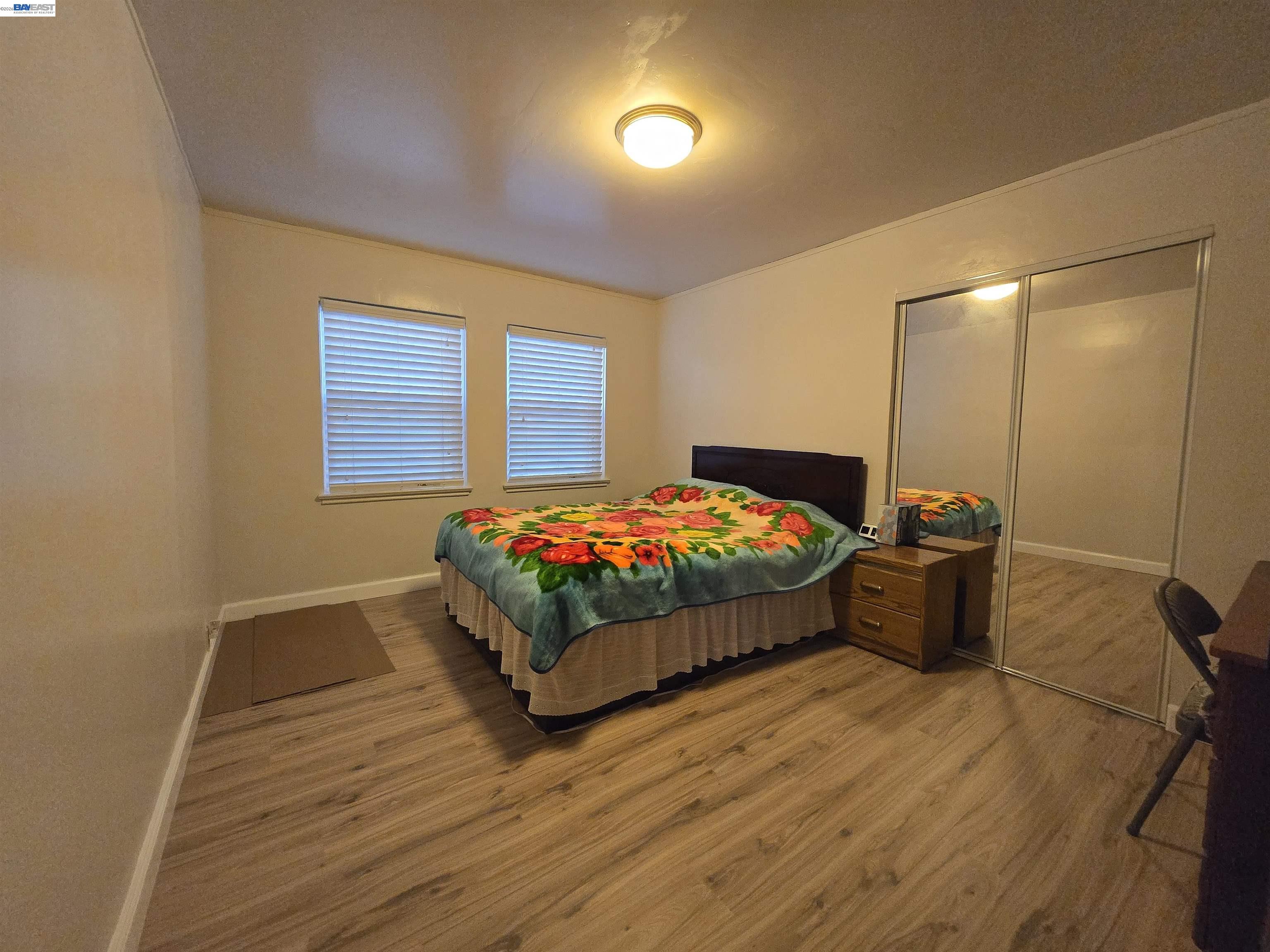 2917 Telegraph Avenue Berkeley, CA 94705 - Photo 9 of 12 a bedroom with a bed and wooden floor