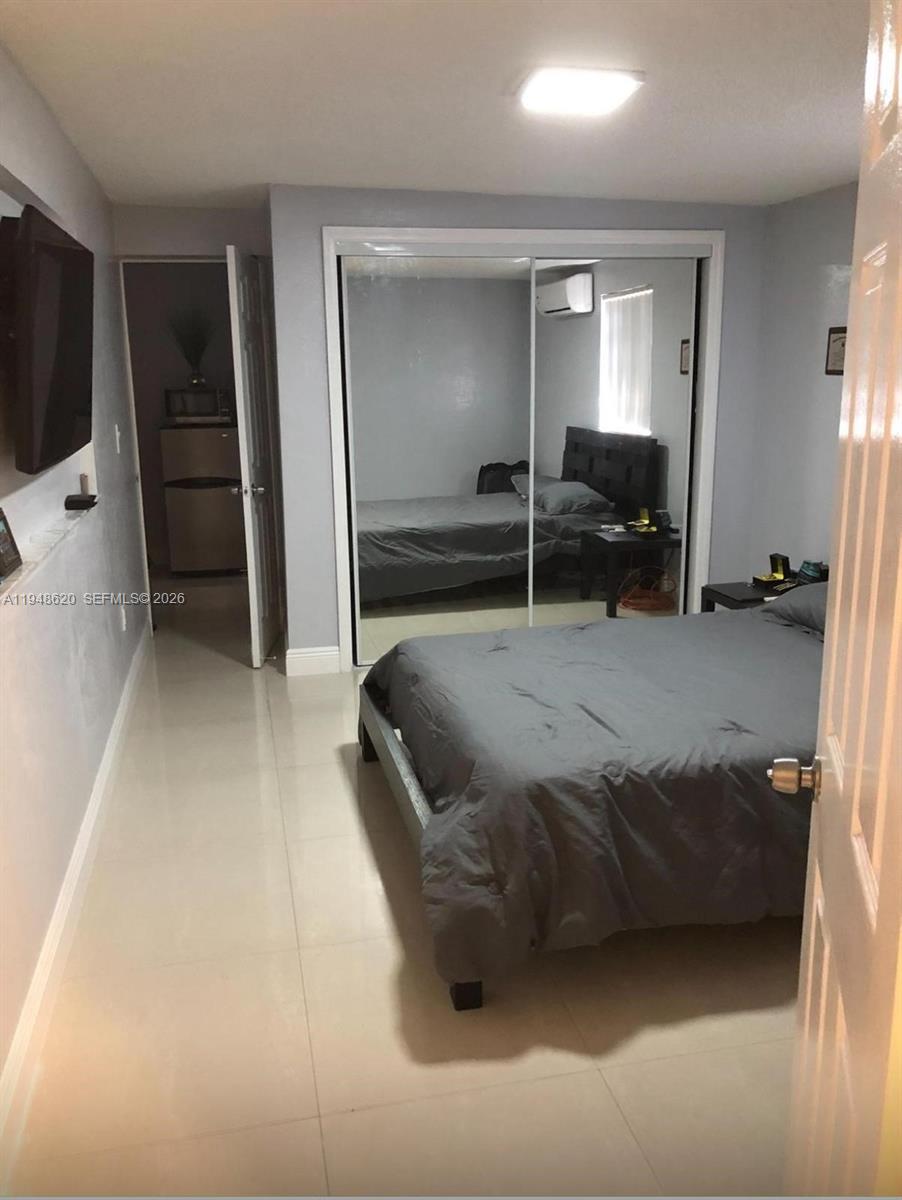 411 West 31st Place, Unit 2 Hialeah, FL 33012 - Photo 4 of 6 a bed room with a bed and a television