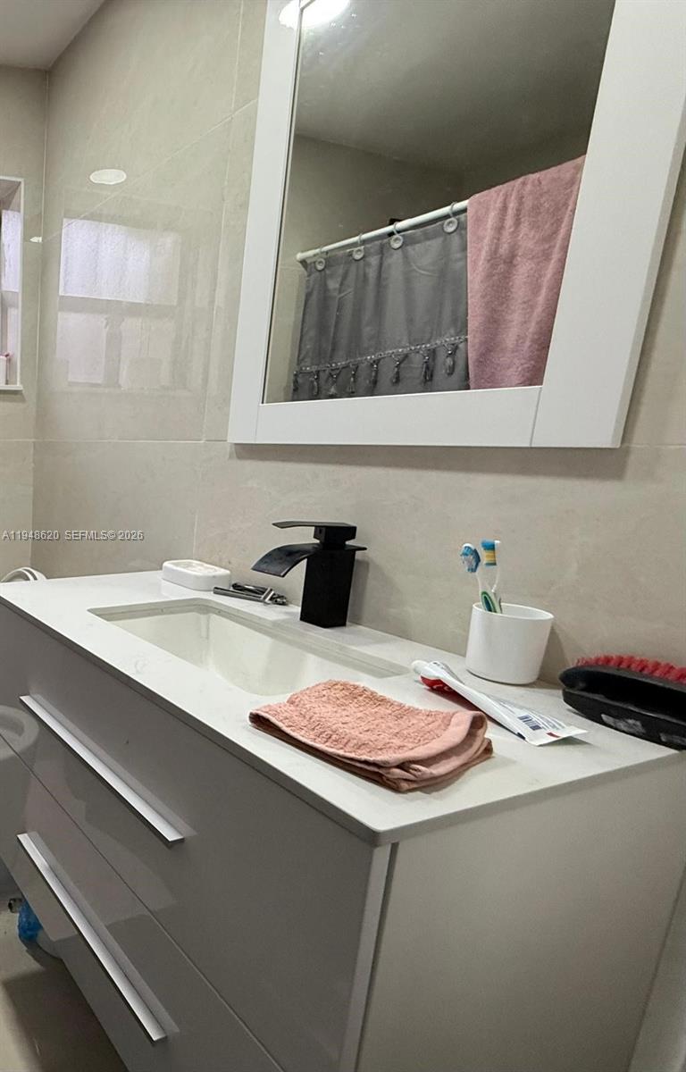 411 West 31st Place, Unit 2 Hialeah, FL 33012 - Photo 5 of 6 a bathroom with a sink and a mirror