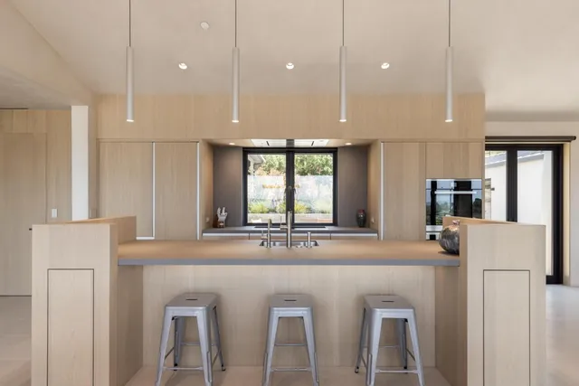 a kitchen with stainless steel appliances granite countertop a sink and a refrigerator