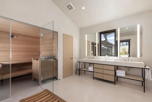 a spacious bedroom with a bed and a window