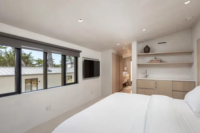 a bedroom with a large bed and a large window