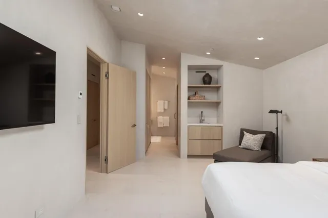 a bedroom with a bed and a television