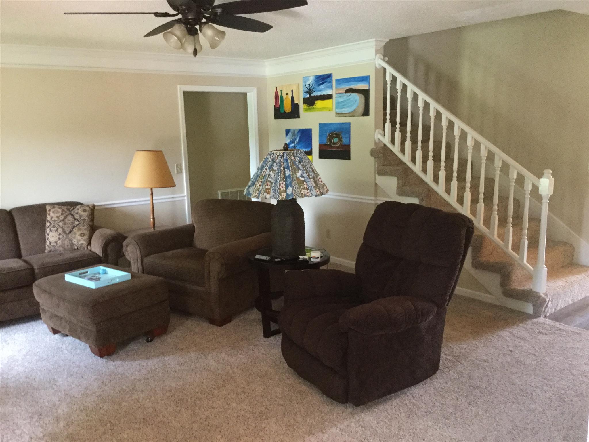 9648 Oregon Road Lascassas, TN 37085 - Photo 12 of 14 a living room with furniture and a lamp