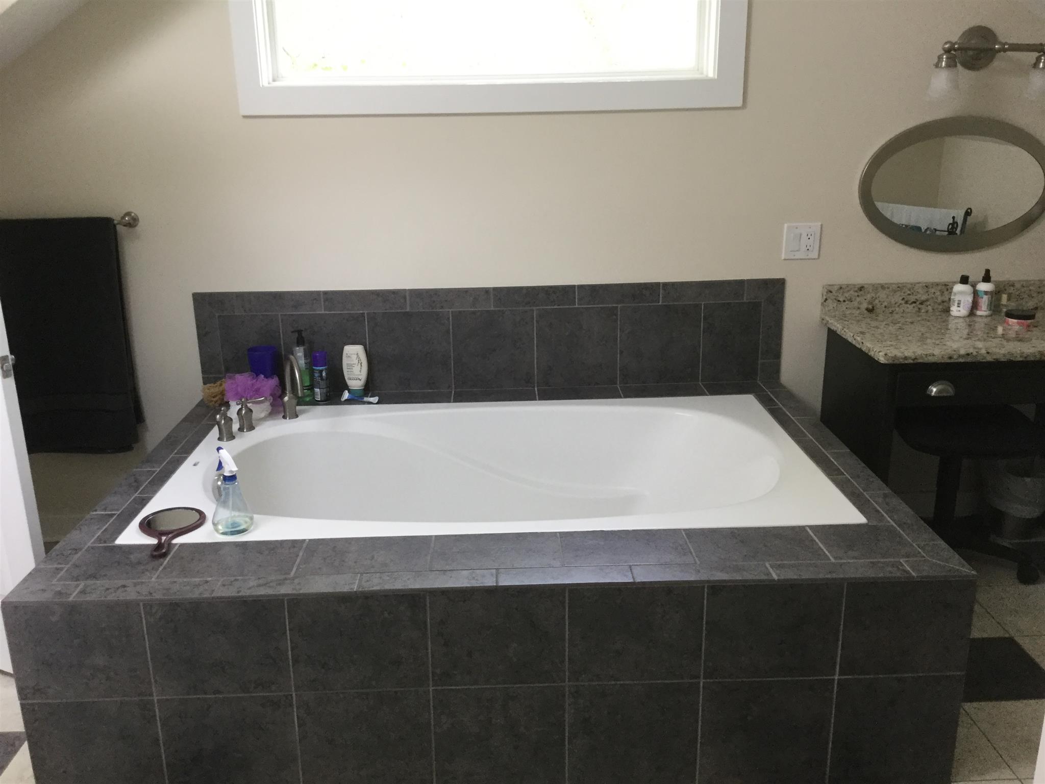 9648 Oregon Road Lascassas, TN 37085 - Photo 9 of 14 a bathroom with a bathtub and a sink