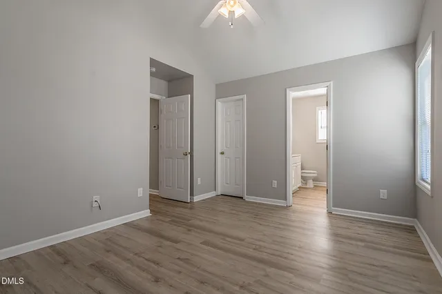 a view of an empty room with wooden floor