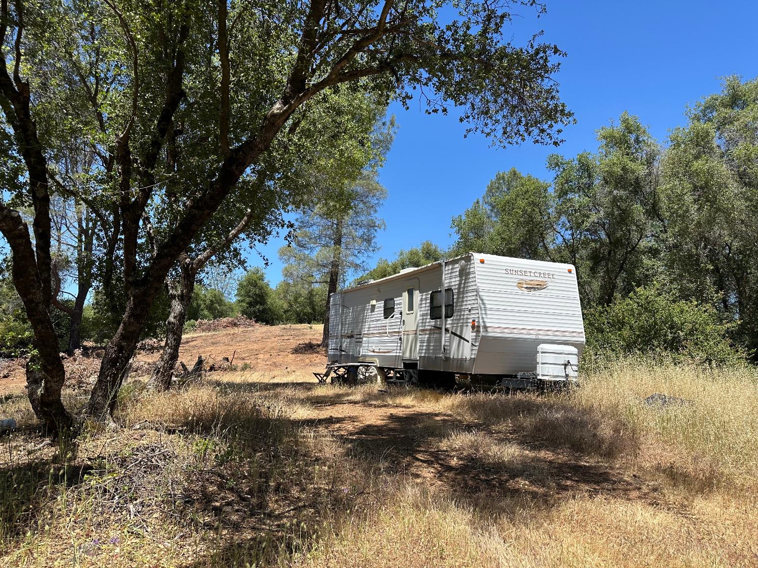 14210 Perimeter Road Grass Valley, CA 95949 - Photo 30 of 33 a white house that has a tree in front of it
