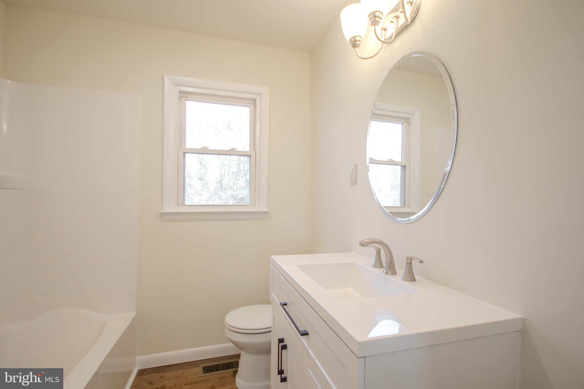 306 Autumn Terrace Salisbury, MD 21804 - Photo 12 of 21 a bathroom with a sink a toilet and a mirror