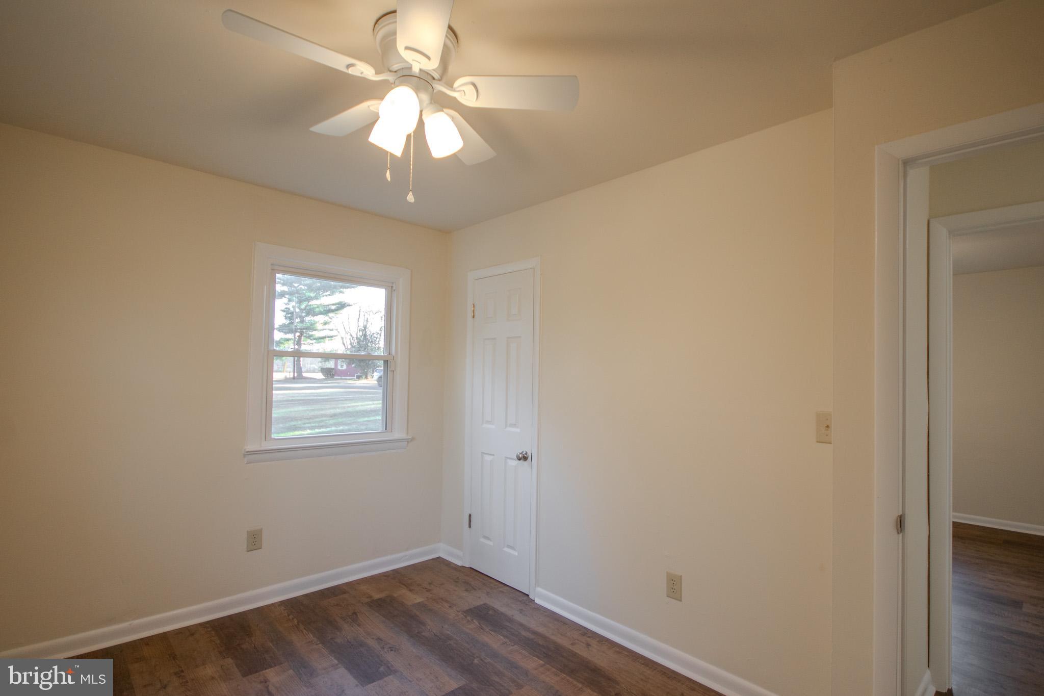 306 Autumn Terrace Salisbury, MD 21804 - Photo 14 of 21 an empty room with a chandelier fan and windows