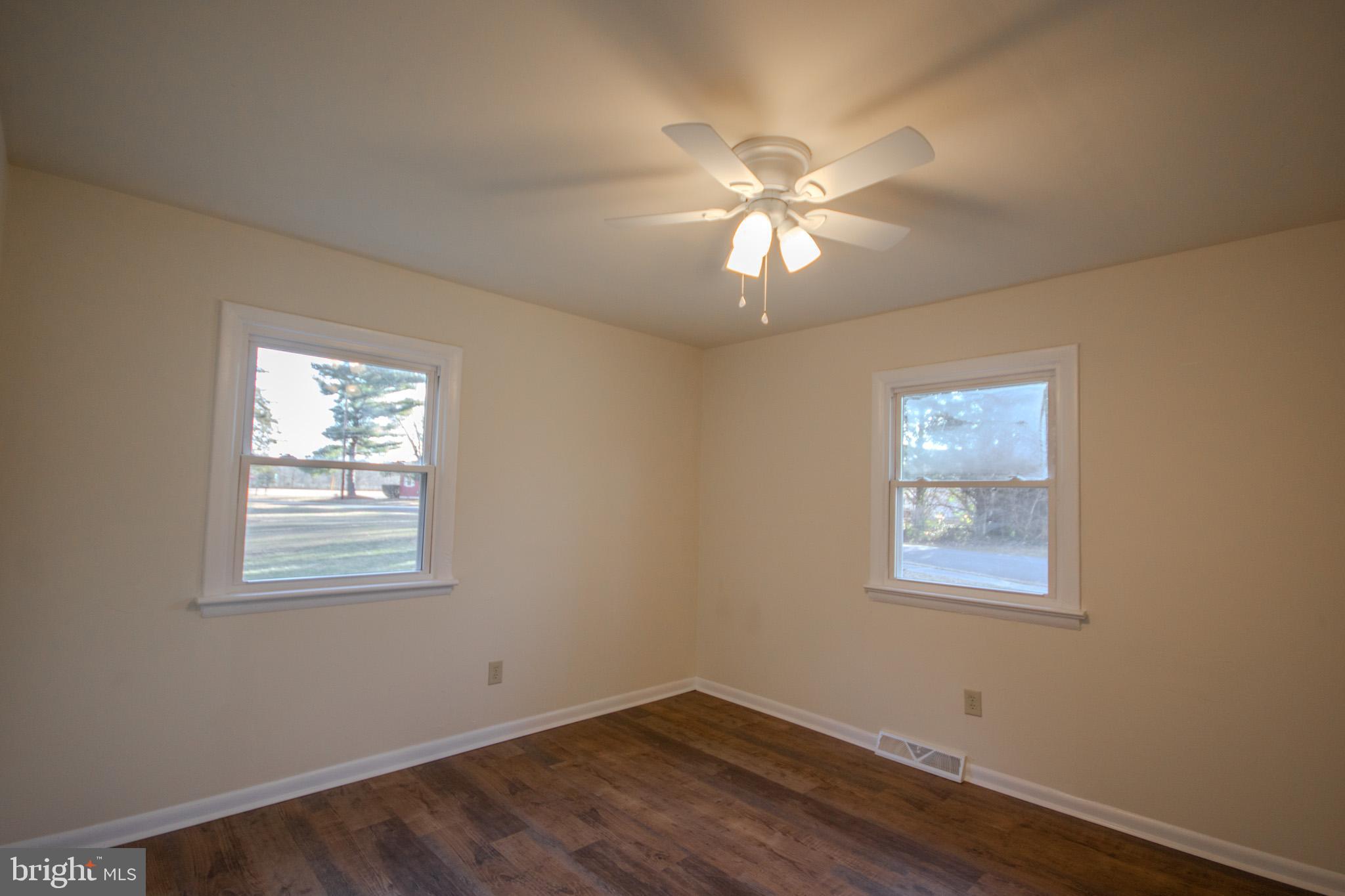 306 Autumn Terrace Salisbury, MD 21804 - Photo 15 of 21 a view of an empty room with a window and wooden floor